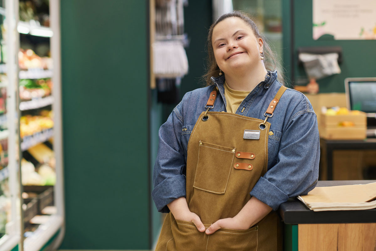 a lady with down syndrom wearing brown bigs in an hardware